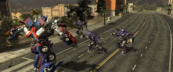 A scene from the game: Optimus Prime's path is blocked by three small Decepticons